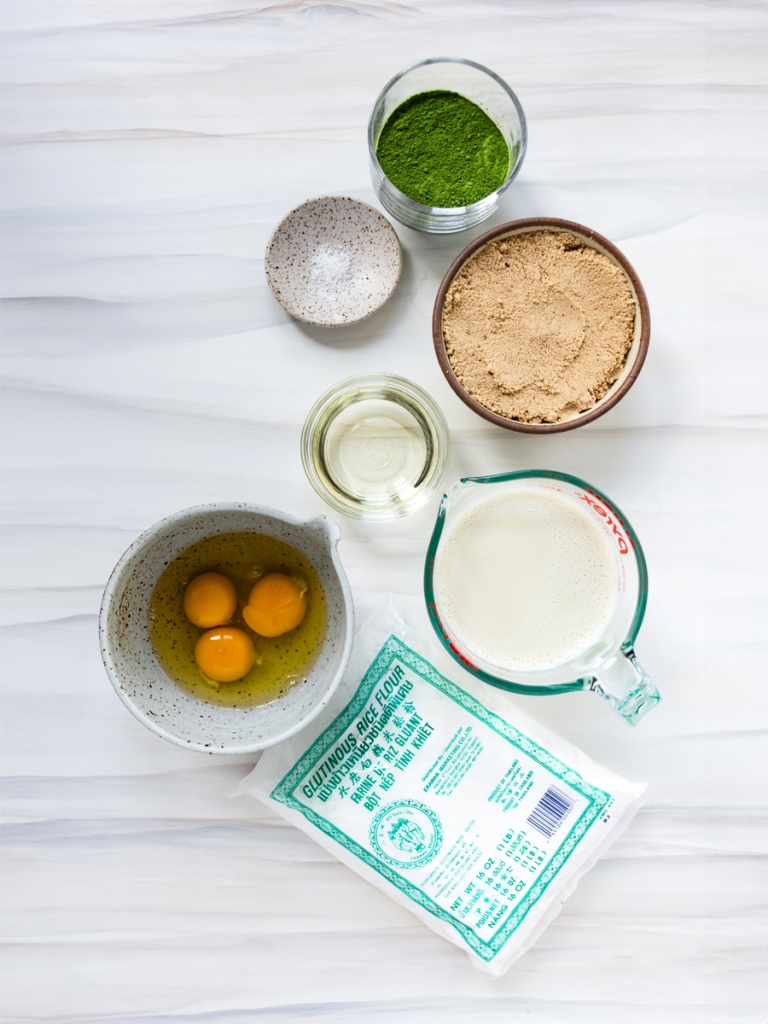 an image of ingredients for matcha mochi cake ((glutinous rice flour, culinary matcha, sugar, sea salt, vegetable oil, milk and eggs)